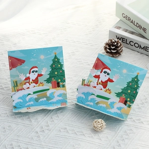 3D pop-up Christmas card featuring surfing Santa with beach tree and gift decorations