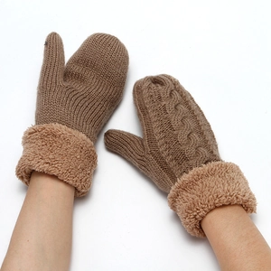 Detail of camel knitted gloves featuring cable patterns and thick plush cuffs