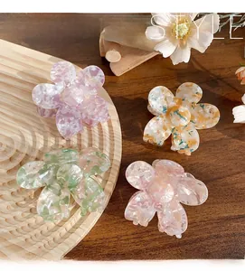 Detailed macro view of acetate floral hair claw clips in pastel colors with marble textures