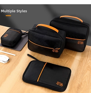 Black and orange 4-piece digital accessory organizer set on a wooden desk surface