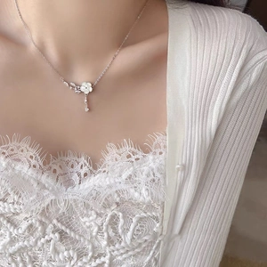 Elegant s925 silver plum blossom flower necklace with sparkling tassels worn by a woman