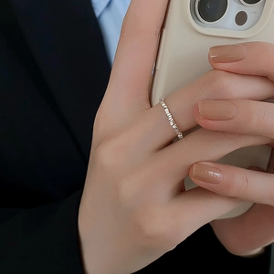 Minimalist silver geometric square ring with faceted beads on model's hand