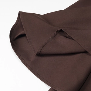 Close-up of brown slim dress fabric texture with high-quality hem stitching detail