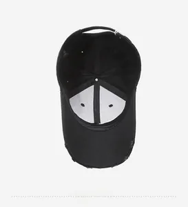 Detail view of black vintage baseball cap interior with stitching and metal buckle