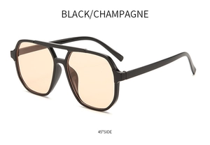 Detail of pilot-style double bridge sunglasses in black frame with champagne lenses