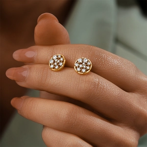 Close-up of gold-plated S925 silver round earrings with pavé white cubic zirconia crystals
