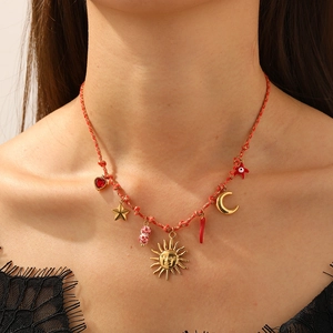 Bohemian colorful woven knot necklace with gold sun, moon, and pepper charms on red cord