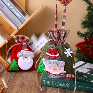 Detailed view of handmade Christmas drawstring gift bags on a cozy wooden holiday tabletop