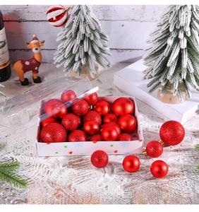Detail of red Christmas ball set with matte, glossy and glitter textures in a clear box