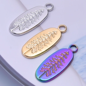 Detailed view of oval tree leaf pendants in silver, gold, and iridescent finishes