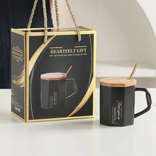 Matte black octagonal ceramic mug set with wooden lid and gold spoon in a gift box