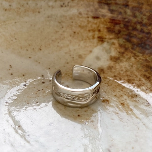 Detailed close-up of irregular hammered texture on a 925 sterling silver ring