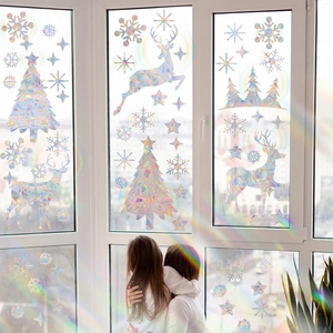 Rainbow holographic Christmas window decals featuring reindeer and tree in sunlight