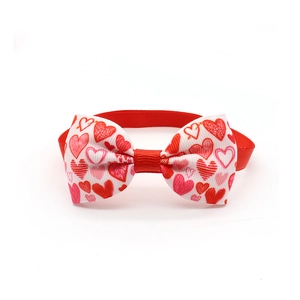 Close-up of heart print dog bowtie in red polyester fabric for Valentine's Day