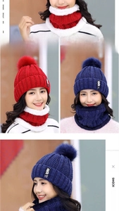 Detailed knit texture of red and blue winter beanies with pom-poms and matching scarves
