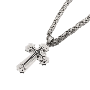 Detailed close-up of double-layered silver and black cross pendant with Byzantine chain