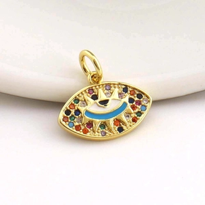 Macro detail of 18k gold plated evil eye pendant with multi-color zircon inlay