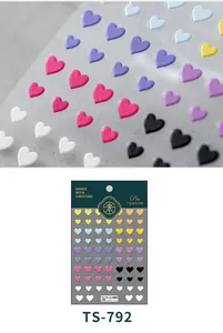 Detailed macro view of 3D embossed heart nail art stickers showing texture and 5D patterns