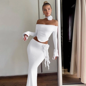 Detail of white rib-knit two-piece set featuring a long sleeve tube top and skirt with flowers