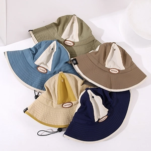 Close-up of contrast color sun hats with adjustable drawcord and leather patch