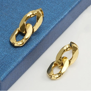 Detailed close-up of 18K gold plated chunky chain earrings on a blue jewelry box