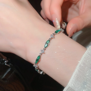 Close-up of sparkling green zircon bracelet with marquise and square cut stones