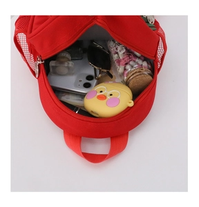 Top view of red kids canvas backpack interior showing spacious storage and mesh side pocket