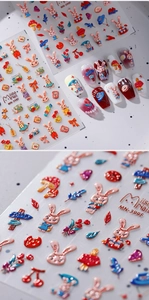 Detail of 3D embossed nail stickers featuring cute cartoon rabbits and floral patterns