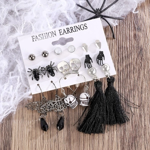 Detailed set of 12 Halloween earrings with skull and spider motifs on a white card display
