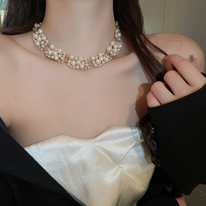 Detail of elegant gold layered choker necklace with premium pearls and sparkling rhinestones