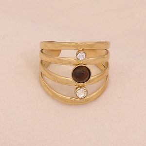 Detail of a gold-plated multi-layer open ring with white zircon and brown tiger eye stone