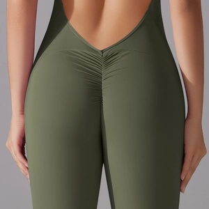 Detail view of deep green yoga jumpsuit with scrunch butt design and open V-shaped back