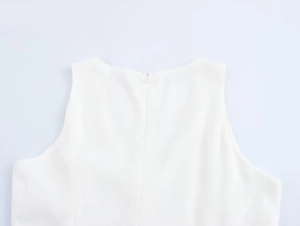 Close-up of invisible zipper and stitching on the back of a white sleeveless dress