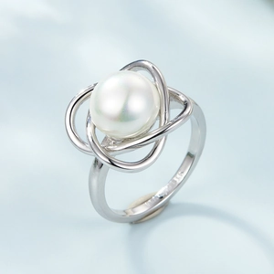 Macro shot of 925 sterling silver ring with round pearl and hollow interwoven band