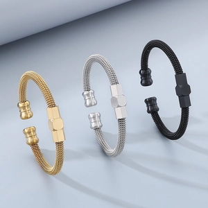 Three stainless steel cable bracelets in gold, silver, and black finish with hexagonal details
