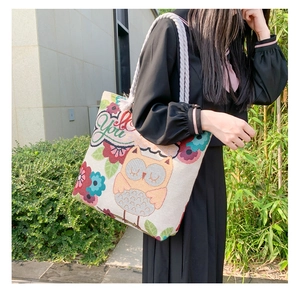 Detail of embroidered owl floral pattern on large canvas tote with rope handle