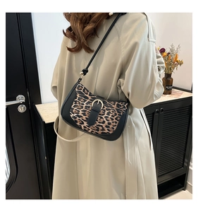 Leopard print underarm bag shown on a model in a trench coat, highlighting the fit and size