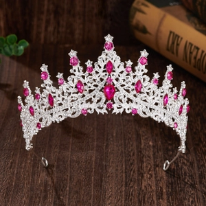 Detailed view of silver bridal crown with pink gemstones and clear crystals on alloy
