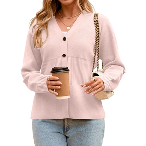 Detailed view of light pink knit cardigan texture and v-neck with dark brown buttons