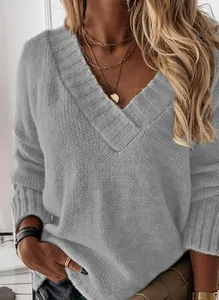 Close-up of gray V-neck knit sweater showing thick ribbed texture and casual long sleeves
