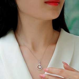 Elegant 925 sterling silver necklace featuring a sparkling round pendant on female model