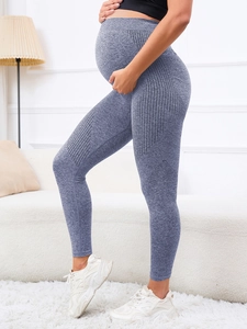Macro detail of breathable mesh texture and seamless knit fabric on maternity yoga pants