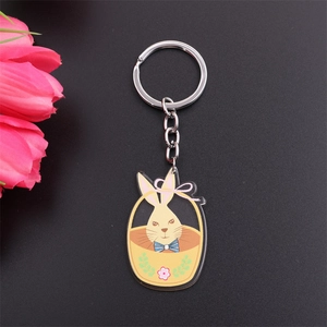 Close-up of a cartoon rabbit in a basket acrylic keychain charm with metal ring and chain