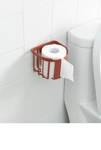 Wall-mounted red-brown bathroom tissue holder showing cutout design on white tile