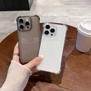 Close-up of clear and black shockproof iPhone cases with reinforced corners on a table