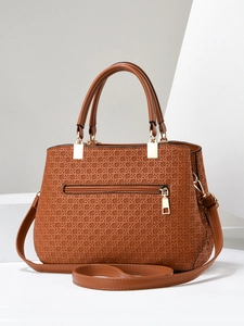 Detail of brown woven textured PU leather handbag with gold metal zippers and strap