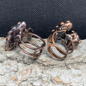 Detailed close-up of vintage bronze adjustable ring with raw amethyst and organic texture