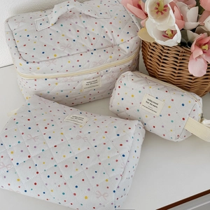 Three-piece quilted cotton makeup bag set with colorful polka dots and pink bows