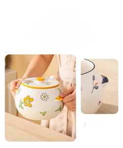 Detail of a ceramic jar with heat-resistant handles and floral daisy patterns