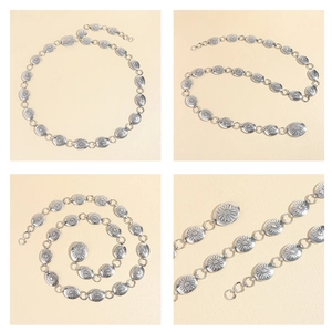 Detailed close-up of vintage silver metal chain belt with engraved daisy flower patterns